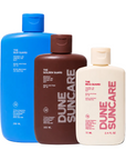 Three bottles of Dune Suncare sunscreen with different sizes on a white background